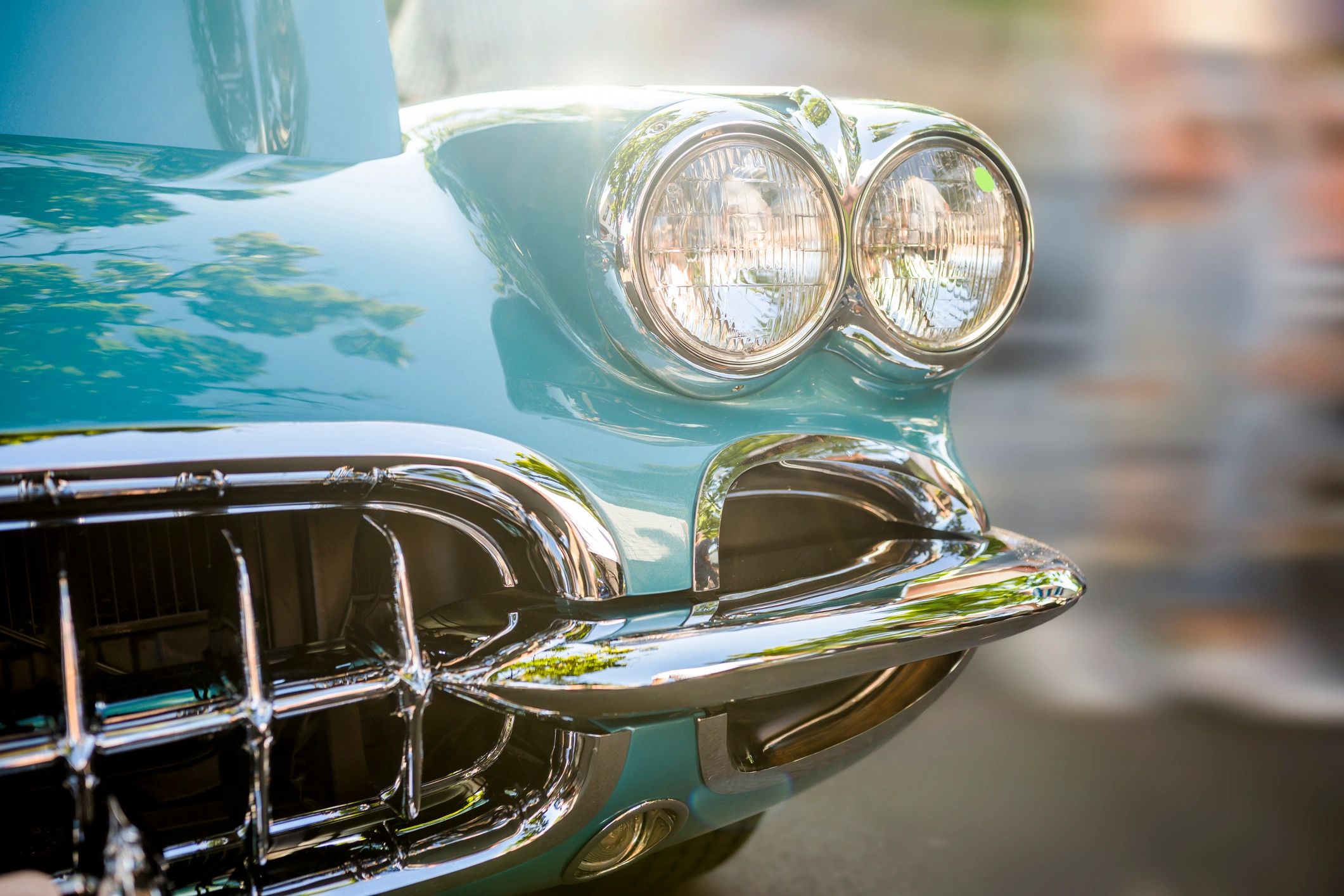 Turquoise vintage car on display at a show