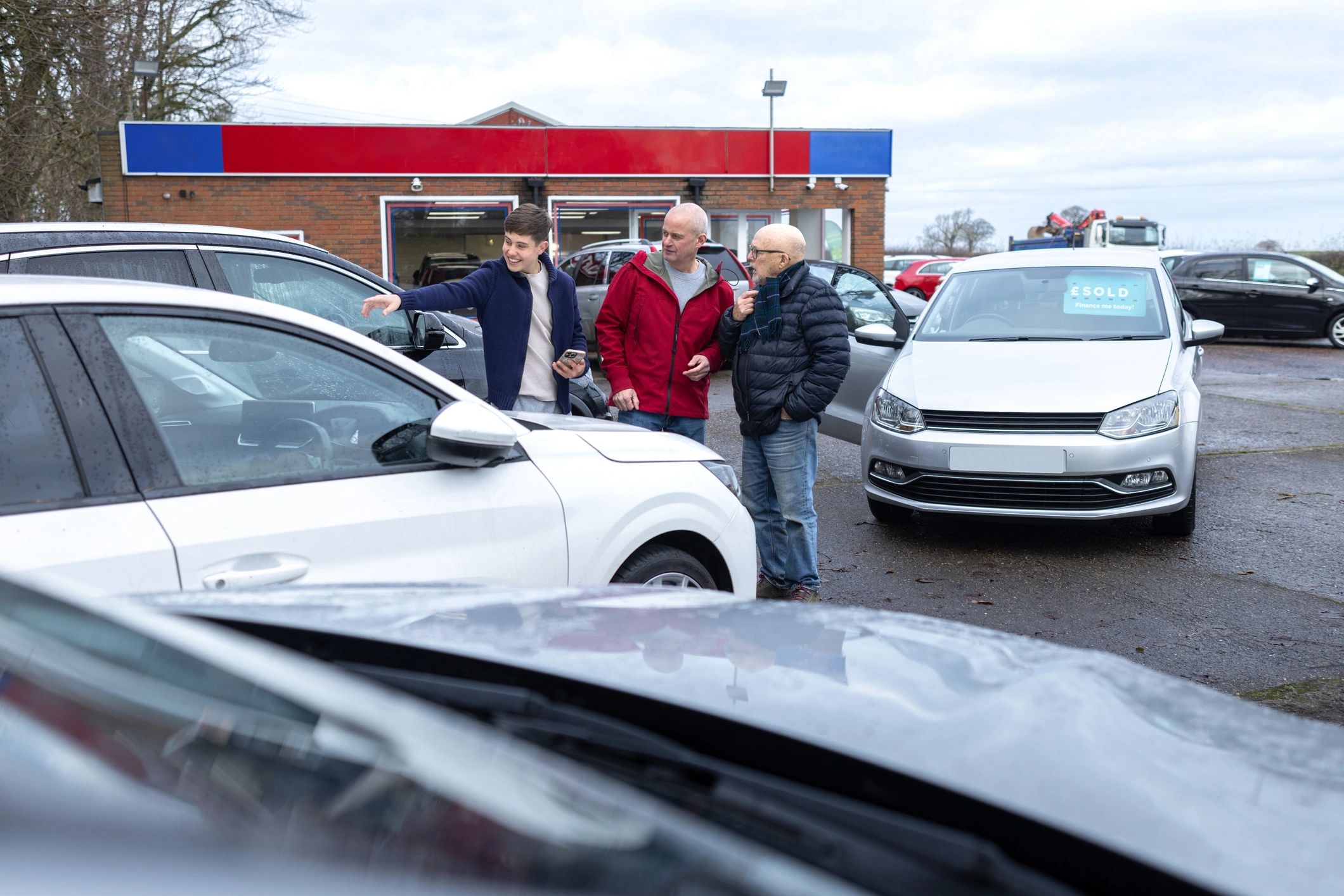 People talking near cars outdoors