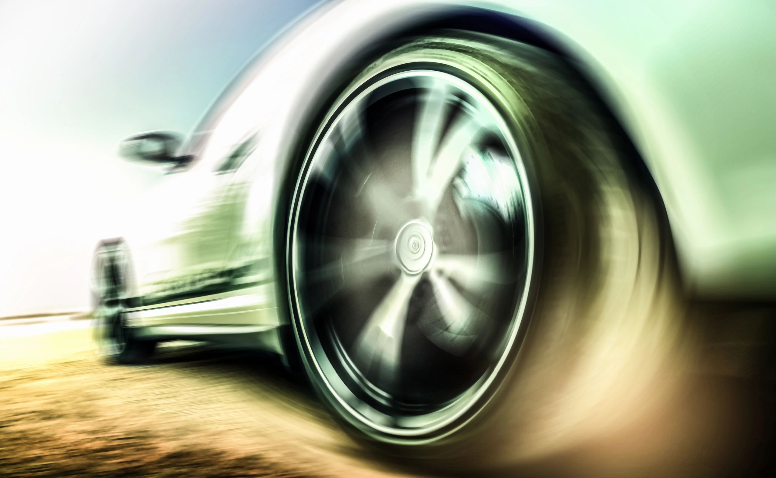 Motion-blurred sports car tire detail